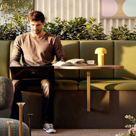 Man working in casual seating area